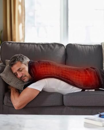 Person using a heating pad on lower back for back pain relief at home